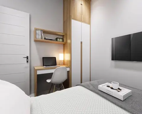 Kamar tidur dengan meja kerja, rak kayu, dan lemari putih yang menyatu