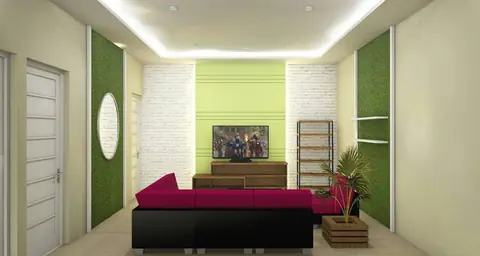 Ruang keluarga dengan dinding hijau, sofa merah tua, dan televisi